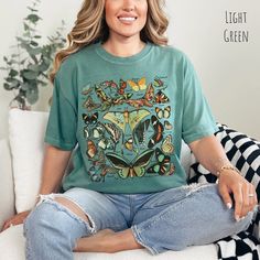 Vintage Butterfly and Moth T Shirt, Comfort Colors, Cottagecore Aesthetic Shirt, Art Shirt, Gift For Her, Nature Lover Tee, Boho Clothing, Botanical Outfit, Cute Shirt For Teen, Gift For Mom, Gardening Shirt, Garden Tee, Science Shirt, Entomology Shirt, Gift for Entomologist, Science Teacher Shirt, Educational TShirt, Vintage Art Shirt, Boho Design, Moth Shirt, Fairycore TShirt 🦋 Step into a world of enchantment and elegance with our Vintage Butterfly & Moth Identification tshirt for women, a masterpiece that seamlessly marries the captivating allure of 26 distinct butterfly and moth species with the timeless comfort of the Comfort Colors brand. Embrace the whimsical charm as you indulge in the delicate beauty of these winged wonders, all elegantly labeled with their respective names. ©️A Casual Green Top With Butterfly Print, Butterfly Print Relaxed Fit Crew Neck Top, Butterfly Print Crew Neck Top With Relaxed Fit, Relaxed Fit Butterfly Print Crew Neck Top, Vintage Cotton Tops With Butterfly Print, Relaxed Cotton Top With Butterfly Print, Fairycore Tshirt, Botanical Outfit, Moth Shirt