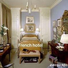 there is a french hotel room with blue walls