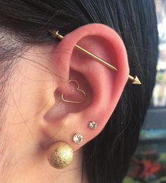 a close up of a person wearing ear piercings