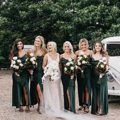 a group of women standing next to each other in front of a white car with flowers