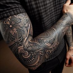 a man with tattoos on his arm and arms