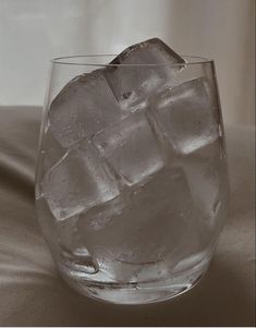 a glass filled with ice on top of a table