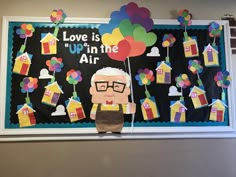 a bulletin board with an elderly man holding balloons in the shape of houses and kites