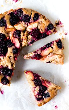 a piece of pie with berries on it is cut in half and ready to be eaten