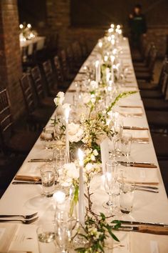 a long table is set with candles and flowers for an elegant dinner or reception party