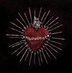 a red heart surrounded by lots of silver pins on a black background with a starburst in the middle