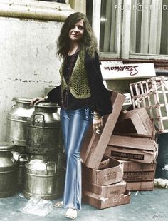 a woman is standing next to some boxes