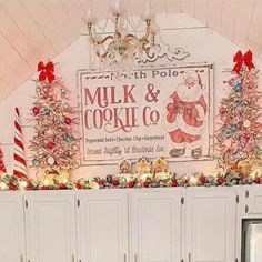 a christmas display in the corner of a room with white cabinets and lights on it