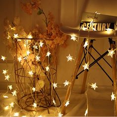 a chair with some lights on it next to a potted plant and a sign