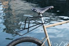 a close up of a bike with water in the background