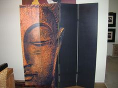 a room divider with an image of a buddha head on it