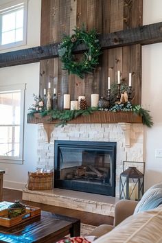 a living room filled with furniture and a fire place covered in christmas wreaths on top of a mantel