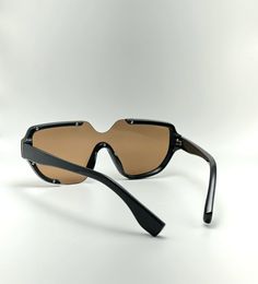 Introducing our newest addition to the sunglasses collection - the UV400 Protection Acetate Frame Semi-Rimless Oval Designer Sunglasses for Men and Women in Black/Gold. Protect your eyes from harmful rays with these non-polarized unisex sunglasses, featuring a lens width of 74 millimeters, a bridge of 18 millimeters and a lens length of 149 millimeters.Enjoy maximum comfort with these lightweight sunglasses that stay in place for longer periods. The black frame coated with gold makes for an eye-catching combination that is sure to uplift your mood. Not only will you look great, but you will also enjoy the high-quality material used to construct these glasses - acetate frames, stainless hinges and fine-grade polarized lenses.We take pride in offering quality products at reasonable prices an Modern Shield Sunglasses For Beach, Rimless Shield Sunglasses With Mirrored Lenses, Modern Rimless Polycarbonate Shield Sunglasses, Modern Polarized Shield Sunglasses For The Beach, Modern Shield Sunglasses With Polarized Lenses For Beach, Modern Polarized Shield Sunglasses For Beach, Rimless Glass Shield Sunglasses With Tinted Lenses, Rimless Shield Sunglasses With Uva Protection, Rimless Tinted Shield Sunglasses