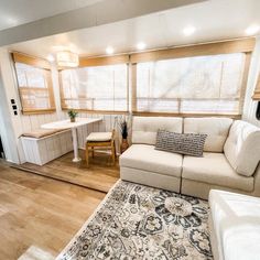 a living room filled with furniture and wooden floors