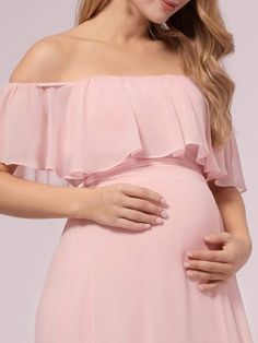 a pregnant woman wearing a pink dress