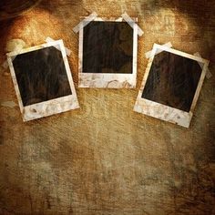 three old photo frames sitting on top of a wooden table