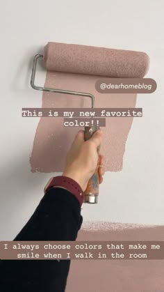 someone is painting the wall with pink paint and there is a quote above it that says, this is my new favorite color