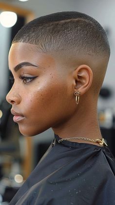 Embrace a bold, minimalist look with a Buzz Cut from our 30 Short 4C Hairstyles guide! This low-maintenance style highlights your natural texture with effortless cool. Click the pin and follow us for more chic and easy hair ideas! #BuzzCut #4CHairstyles #NaturalHair #EffortlessChic #BoldStyles Fade On Women, Low Fade Women, Stud Haircut Black, Fade Black Woman, Afro Pixie Haircut, Black Woman Buzzcut, Rose Gold Hair Black Women, Black Women Shaved Head, Black Women Buzzcut