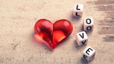 two dices with the words love written on them and a heart in the middle