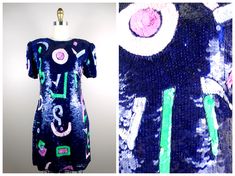 "This trophy dress beautifully embellished with multicolored sequins and accented with beading! Amazing!! It's in excellent condition! Measurements: Bust - 34\" Waist - 29\" Hips - 40\" Length - 35\" Tag Size - Medium This dress comes from a pet-free and smoke-free home. If you would like more info or have any questions, please don't hesitate to ask!" Festival Fitted Sequin Dresses, Fitted Sequin Festival Dresses, Fitted Embellished Festival Dress, Blue Fitted Dress For Festival, Sequin Dresses For Evening Festivals, Multicolor Festival Dresses For Party, Purple And Neon Green, Sequined Mini Dress, Mini Dress Blue