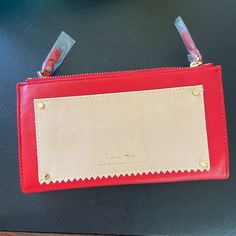 Brand New (In Box) India Hicks Red Take Out Wallet. 8 X 4.5 X1.5 Exterior: Beautiful Red Smooth Leather With Soft Light Tan Leather Patch Pocket On Front Side Zippers And Hardware Gold With Snaps On Top Side Fold To Close. Interior : Light Beige Linen Lining With Red Phone Snaped Pocket In Sizeable Center Pocket Double Zipped Pockets On Either Side Of Purse : Both Light Beige Linen Back Pocket With 6 Interior Credit Card Slots Front Pocket With Divider For Currency, Reciepts Rectangular Red Wallet With Zipper Closure, Red Rectangular Wallet With Zipper Closure, Red Wallet With Interior Card Slots For Daily Use, Red Leather Wallet With Removable Pouch, Red Pouch Wallets For Daily Use, Red Rectangular Clutch With Interior Card Slots, Rectangular Red Clutch With Interior Card Slots, Red Everyday Pouch Wallet, Red Clutch For Everyday Use