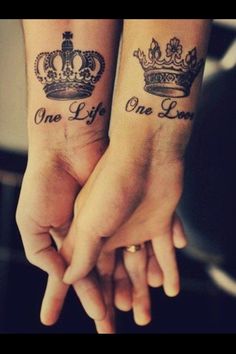 two people holding hands with tattoos on their arms and the words one life, one love