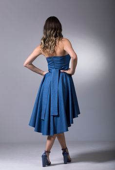 "Strapless Denim Dress, Asymmetric Dress, Let your outfit do all the talking when you step out wearing this trendy denim dress that features an asymmetric high-low hem. The dress features an elegant fit and flare design that flares out from the waist down. The front features an elevated flap-like design that gives it an avant-garde look, perfect for all women who enjoy edgy and bold outfits. Wear this dress on that next night out with friends and enjoy all eyes on you. 🌀 Materials & Care De Wedding Guest Outfit Cocktail, Midi Gown Dress, Strapless Denim Dress, Indigo Dress, Bold Outfits, Midi Gowns, Denim Bustier, Dress Jeans, Denim Maxi Dress