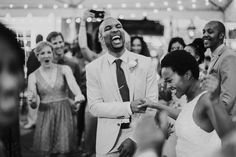 a man in a suit and tie dancing with people