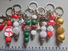 several christmas themed key chains on a ruler