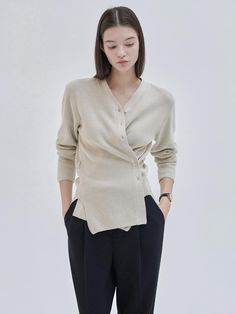 This is NILBY P’s modest and feminine cardigan that can be worn in two ways. It features a slim belted cardigan style with a mid-length design, which can be worn neatly or as a wrap-style pullover for a feminine look. When worn as a wrap, you can adjust the silhouette using the inner adjustment device and outer buttons. It's a versatile item that provides both simplicity and elegance, perfect for styling.- Ideal for daily wear- Can be paired with various bottoms to create different looks- Features buttons on the front for easy removal Neutral V-neck Cardigan For Work, Versatile Beige Sweater For Work, Elegant Long Sleeve Neutral Cardigan, Chic Neutral Cardigan For Work, Chic Wrap Sweater For Workwear, Chic Wrap Sweater For Work, Versatile Wrap Cardigan For Work, Elegant Beige Cardigan For Workwear, Elegant Beige Cardigan For Work