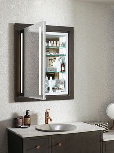 a bathroom with a sink, mirror and medicine cabinet