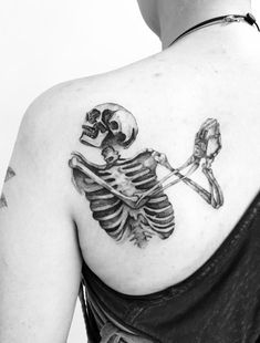 a woman with a skeleton tattoo on her back