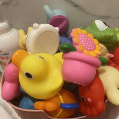 a bowl filled with lots of toys on top of a counter