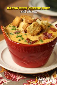 a bowl of bacon beer cheese soup with croutons in it on a plate