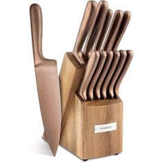 a set of knives sitting on top of a wooden block