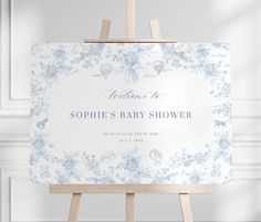 a baby shower sign sitting on top of an easel