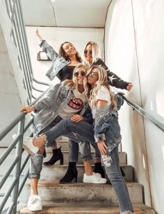 four girls are posing on the stairs together