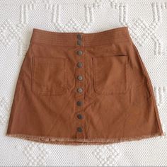 An Easy A-Line Skirt With A Cutoff Hem For A Diy Feel. Patch Pockets And Snaps Give It A Cool Old-School Vibe(Just Right With A Striped Tee Or Tank) Cotton-Elastane Machine Wash Import Brown Cotton Mini Skirt With Pockets, Casual Brown Mini Skirt For Day Out, Casual Beige Mini Skirt With Button Closure, Brown Mini Skirt With Pockets For Spring, Brown Button Closure Skirt For Summer, Spring Brown Mini Skirt With Pockets, Brown Skirt With Button Closure For Summer, Trendy Brown Mini Skirt With Buttons, Brown Buttoned Casual Mini Skirt