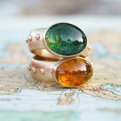 A yellowish orange tourmaline is flanked by satin 14k yellow gold on a 7mm wide, studded band. This is a regal, one-of-a-kind ring, like the color of honey and the rarity of saffron. Size 8.25. Satin finish. Solid 14k Yellow Gold. Keep in mind, when choosing a wider ring band, you will need to size up between a half to three quarters of a size from what you might be used to. The wider the band, the more you'll need to size up. Not exactly what you're looking for? Check out our customs page. Gold Tourmaline Rings With Gemstone Accents, Gold Rings With Tourmaline Gemstone Accents, Verdant Green, Stop Staring, Wide Rings, Wide Band Rings, Green Tourmaline, Ring Band, Rarity