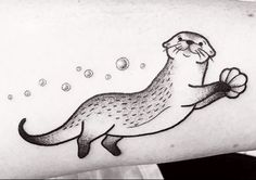 a black and white photo of an otter tattoo on the left inner arm, with bubbles coming out of its mouth