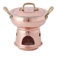 a large copper pot with two handles on the top and bottom, sitting on a white background