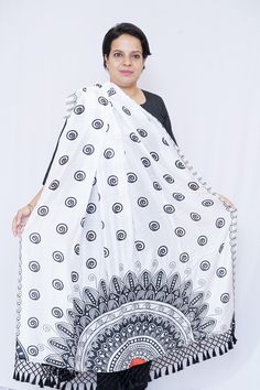 Take in the splendour of this stunning and flawlessly woven Silk Dupatta adorned with mandala art. The black tassels and black and white color scheme contribute to the beauty of this design. Specifications: Brand- Mudita by Lejina Length - 2.5 Meters Color - Black & white Material - Silk. Care Instruction: Dry Clean Only Country of Origin: India Features: 1. The silk dupatta is adorned with digitally printed mandala art. 2. This silk dupatta will have you looking your most gorgeous every season. 3. For a sophisticated touch, this silk dupatta is delicately fashioned with tassels. 4. A fantastic present for women and girls for any occasion. 5. The silk dupatta comes with Customizable colours. Bohemian White Dupatta With Printed Motifs, Bohemian Festival Dupatta With Printed Motifs, White Bohemian Dupatta For Festive Occasions, Festive White Bohemian Dupatta, Festival Dupatta With Printed Motifs And Traditional Drape, Festival Dupatta With Printed Motifs In Traditional Drape, Traditional Dupatta With Printed Motifs For Festivals, White Dupatta With Printed Motifs For Festivals, Navratri White Block Print Dupatta