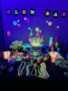 neon glow party supplies and decorations on a table