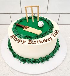 a birthday cake with a cricket ball and bat on it