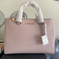 Brand New Never Used Michael Kors Soft Pink Handbag/Satchel. Comes With Strap That Can Convert Purse To Satchel. No Defects. Tag Still Attached. Perfect Condition. Stuffing Still Inside! Michael Kors Satchel For On-the-go, Michael Kors Rectangular Satchel With Handle Drop, Michael Kors Tote Satchel For On-the-go, Michael Kors Satchel With Top Carry Handle, Michael Kors Tote Satchel With Top Carry Handle, Michael Kors Satchel With Double Handle, Michael Kors Double Handle Satchel With Top Carry, Michael Kors Classic Satchel For Daily Use, Classic Michael Kors Satchel For Daily Use