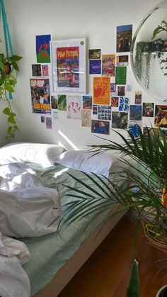 a bedroom with plants and pictures on the wall