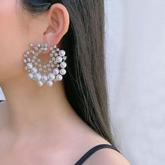 Add an extra dose of elegance to your look with these beautiful pearl earrings. Made of 18K White gold plated, this set is sure to uplift your look. Vaunting a captivating design, is an illustration of fine craftsmanship. It is further enhanced with white cubic zirconia stones that lend it a refining touch. Add a touch of elegance to your outfit with these stunning white pearl round earrings from Barbie Brides. The earrings feature a delicate design with silver and white tones, excellent cut grade cubic zirconia, and imitation pearls that will catch the eyes of anyone. Perfect for any occasion such as wedding, anniversary, graduation, and Valentine's Day, these earrings will add beauty and charm to your look. Crafted with high-quality copper and coated with nickel-free 18K white gold, thes Cubic Zirconia Round Pearl Earrings For Party, Elegant Pearl White Earrings For Party, Glamorous Pearl Earrings As Gift, Round Pearl Bridal Earrings For Party, Round Pearl Bridal Earrings For Evening, Silver Pearl Earrings For Party, Pearl White Hoop Earrings For Party, Party Pearl White Pearl Hoop Earrings, Party Pearl White Hoop Earrings