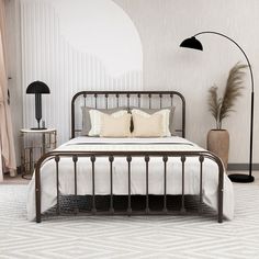 a black metal bed with two lamps on either side