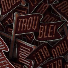 a pile of brown street signs sitting next to each other