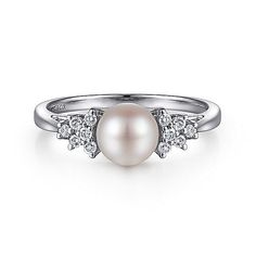 A lustrous round pearl is the shining centerpiece of this timeless stackable ring. The tapered band of polished 14K white gold arches up to clusters of prong set 0.11ct round diamonds. With its classic appeal, this ring appears lit from within. The Shining, Stackable Ring, Pearl Diamond, Stackable Rings, Prong Setting, Women Rings, Round Diamonds, Beautiful Jewelry, Silver Rings